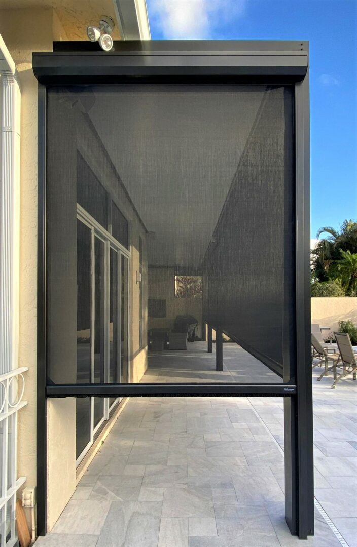 A screen door that is open on the outside of a building.