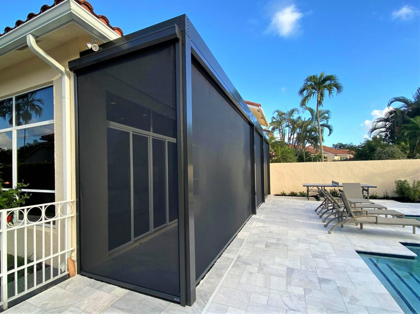 A black awning is attached to the side of a house.