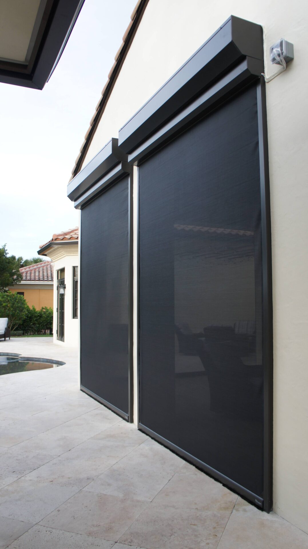 A black awning is on the side of a house.