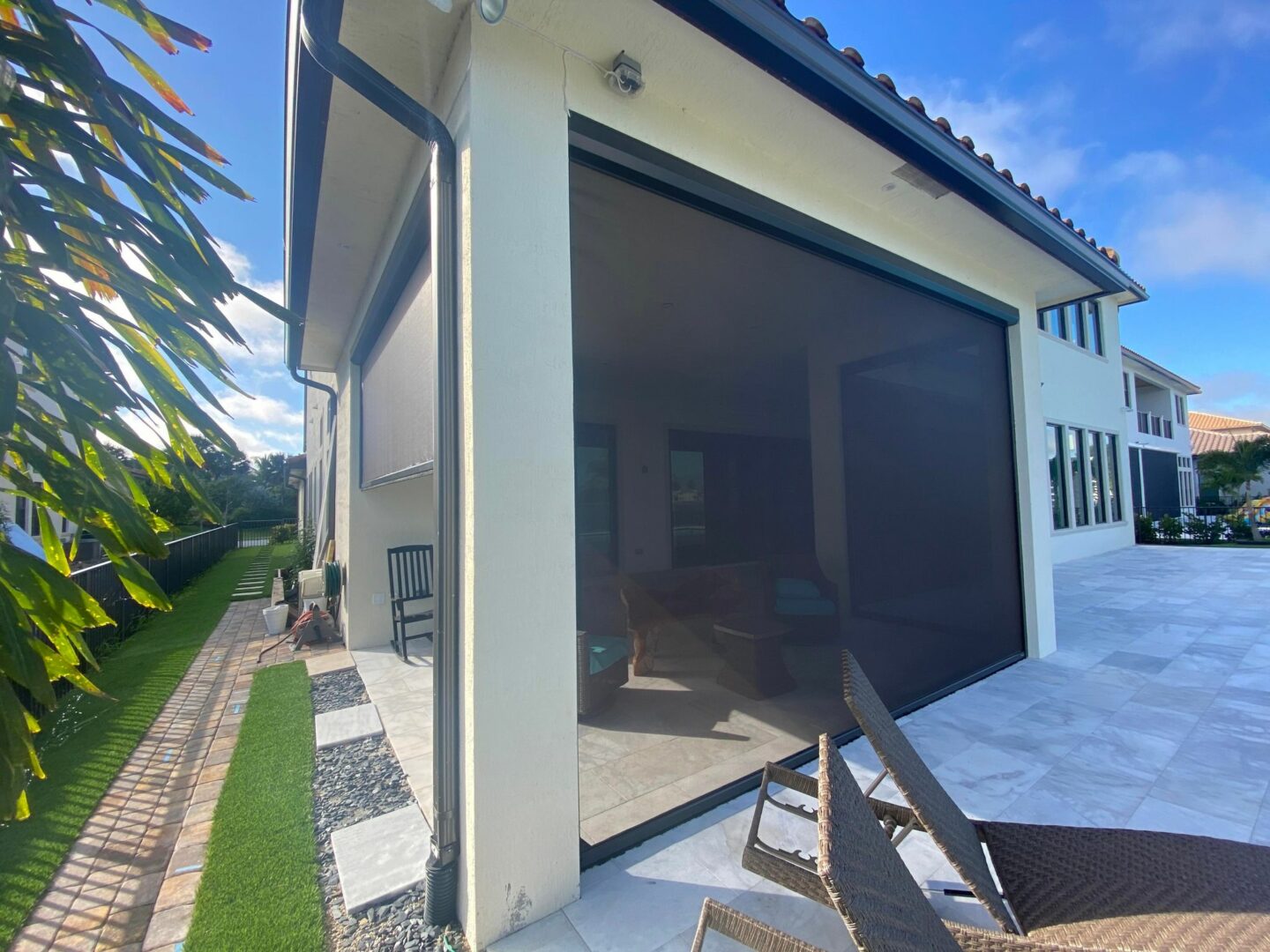 A patio with an awning and screen in it