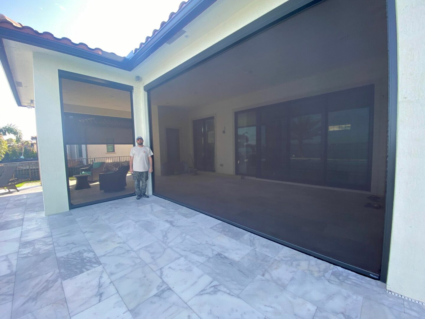 A person standing in front of an open garage door.