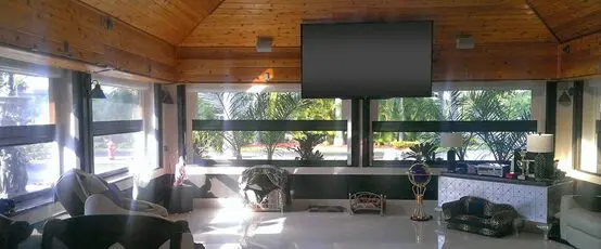 A room with a large window and a tv screen.