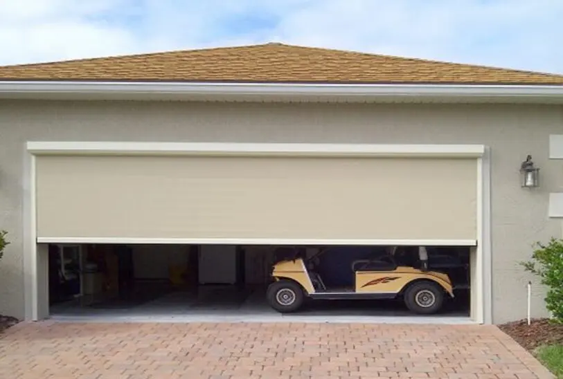 A golf cart parked in the garage of a house.