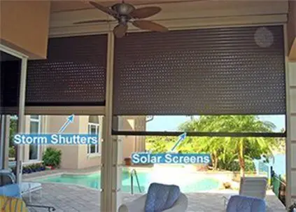 A patio with a pool and sun screens